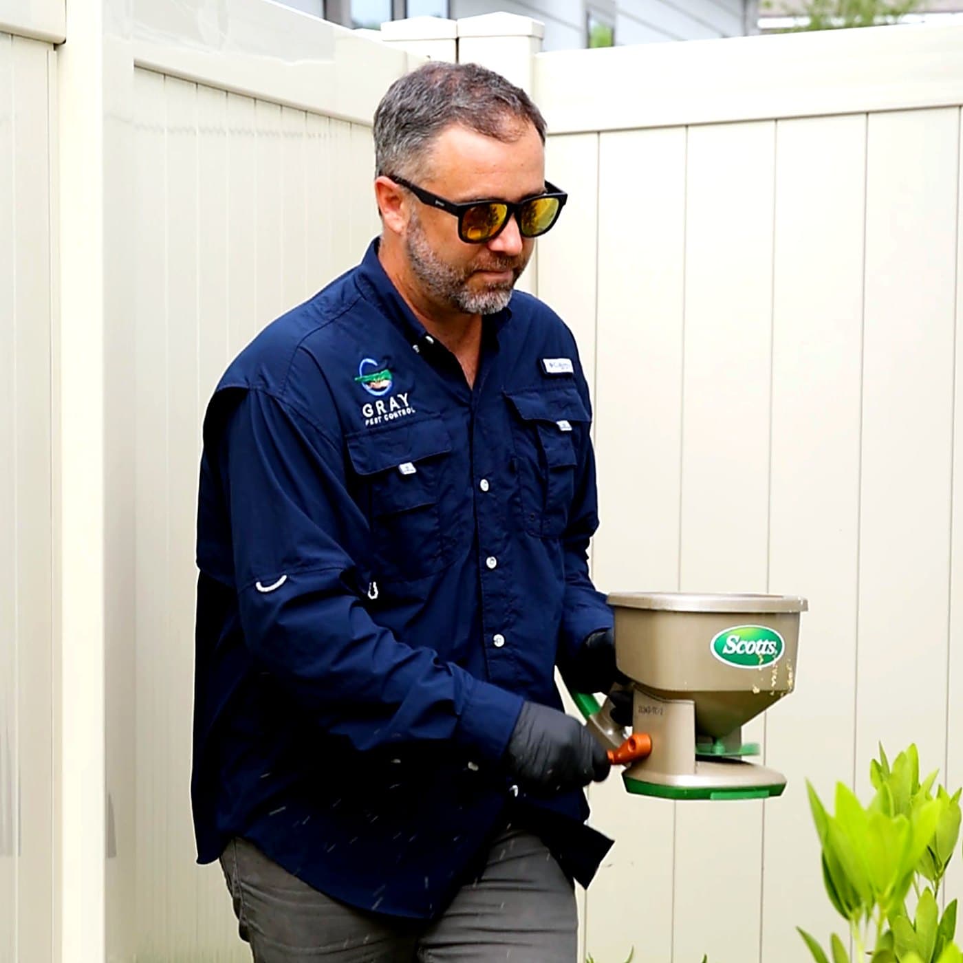 Gray Pest Control technician treating a Northeast Florida yard for mosquitoes