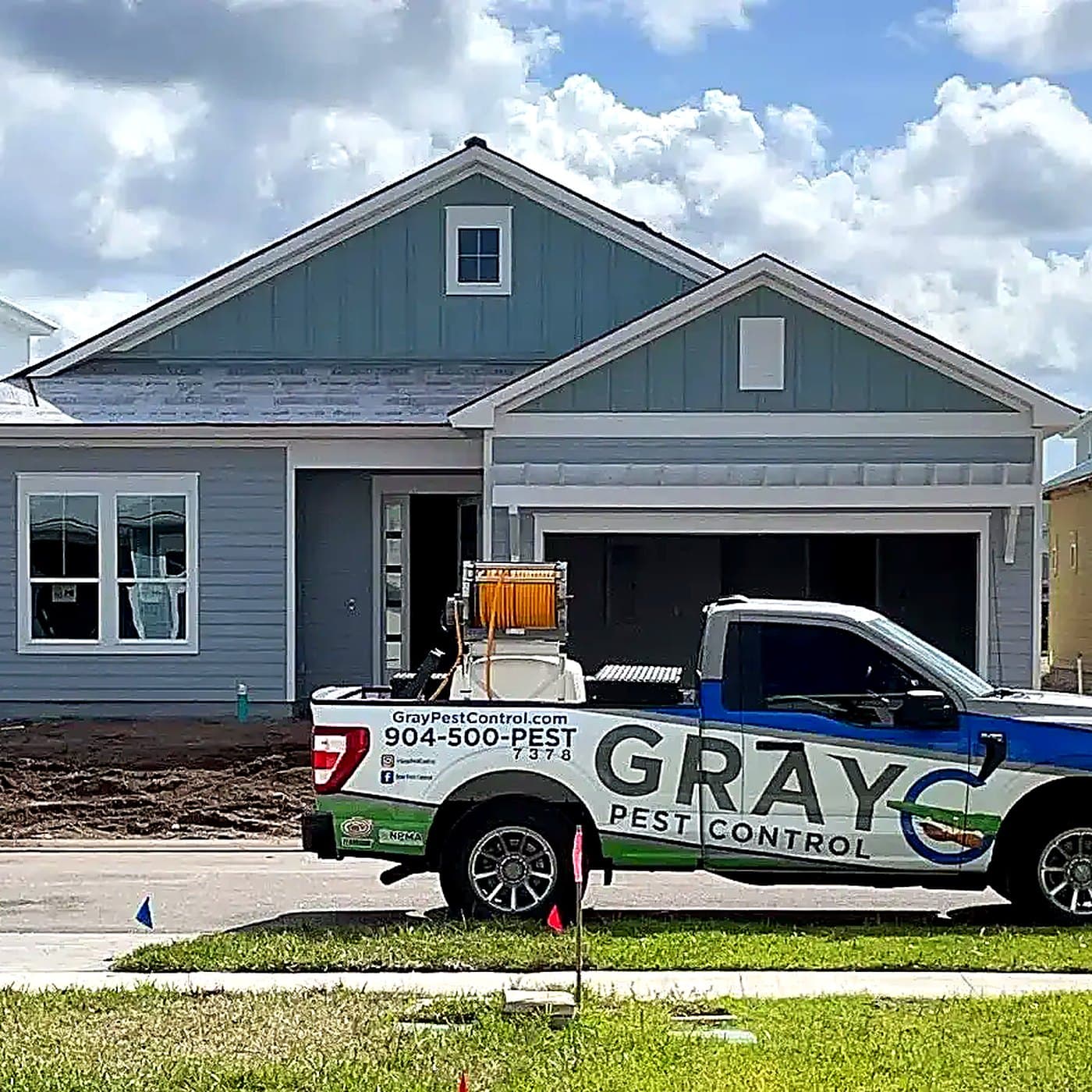 Gray Pest Control inspector performing a WDO inspection at a Northeast Florida home