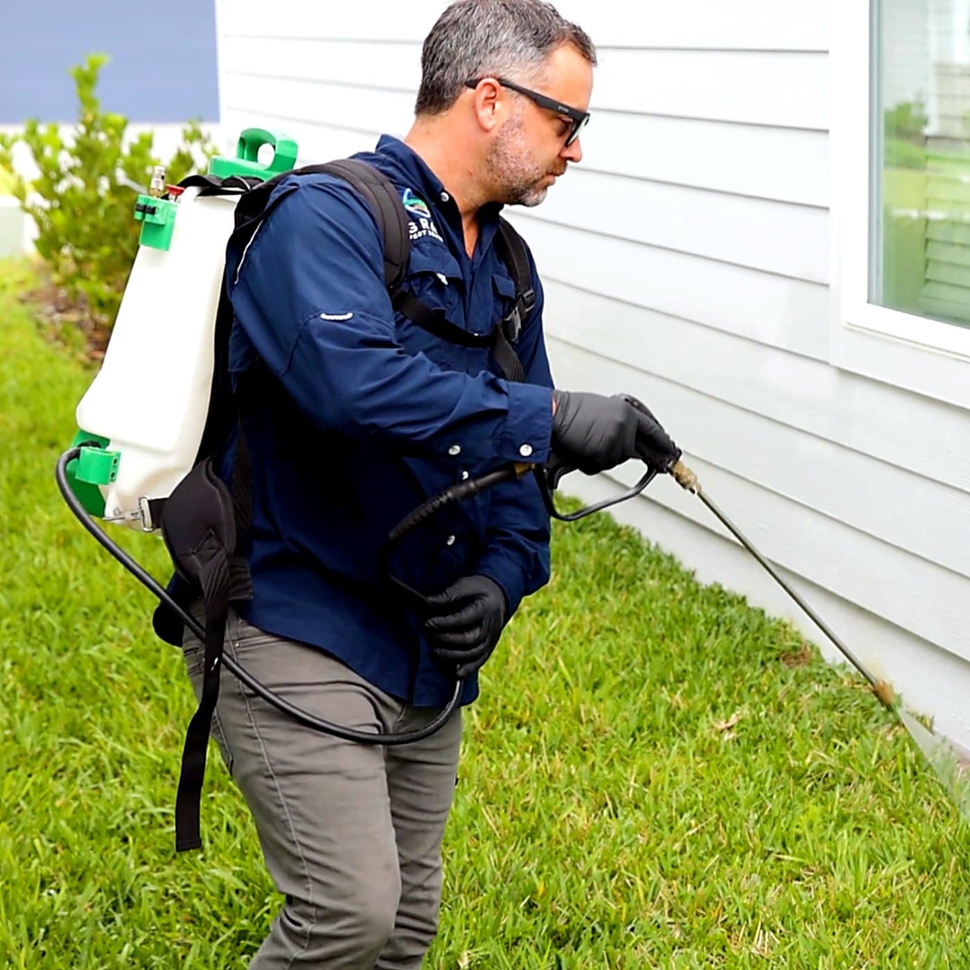 Gray Pest Control technician treating a Northeast Florida home for cockroaches
