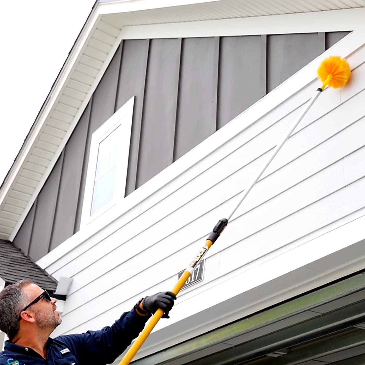 Gray Pest Control technician treating a Northeast Florida home for spiders