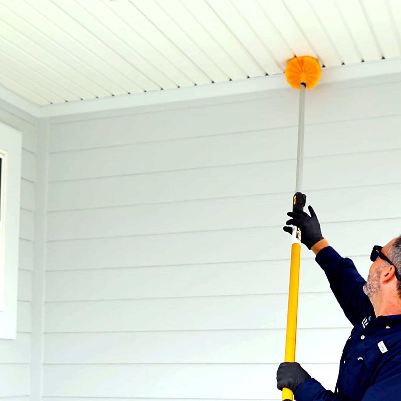 Gray Pest Control technician treating a Northeast Florida home for wasps and stinging insects